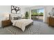 Serene bedroom with a plush bed, modern artwork, and sliding glass doors to a balcony at 8414 N Central Ave # B, Phoenix, AZ 85020