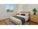 Minimalist bedroom with a sleek bed frame, modern art, and a large window for natural light at 8414 N Central Ave # B, Phoenix, AZ 85020