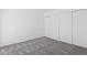 This bedroom has a spacious closet and comfortable gray carpeting at 8414 N Central Ave # B, Phoenix, AZ 85020