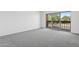 Bedroom featuring neutral carpet and sliding glass door to the outdoor balcony at 8414 N Central Ave # B, Phoenix, AZ 85020