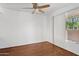 Well-lit bedroom featuring a ceiling fan, closet and large window at 8414 N Central Ave # B, Phoenix, AZ 85020