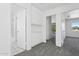 Hallway with storage cabinets, neutral carpet flooring and doorways to living spaces with exterior views at 8414 N Central Ave # B, Phoenix, AZ 85020