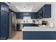 Modern kitchen featuring navy blue cabinets, stainless steel appliances, and white marble countertops at 8414 N Central Ave # B, Phoenix, AZ 85020