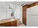 Bright kitchen with wood-look flooring, white appliances, and a window offering natural light and view of the outdoors at 8414 N Central Ave # B, Phoenix, AZ 85020