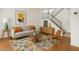 Bright living room with a comfortable gray sofa, colorful rug, and modern decor accents at 8414 N Central Ave # B, Phoenix, AZ 85020