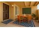 Cozy front patio with stylish seating, door with ironwork detail, and decorative wall art at 8414 N Central Ave # B, Phoenix, AZ 85020