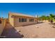 Backyard of home featuring gravel landscaping, lush trees, and a covered patio at 8627 W Morrow Dr, Peoria, AZ 85382