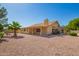 Backyard of home featuring gravel landscaping, a patio, and lush trees at 8627 W Morrow Dr, Peoria, AZ 85382