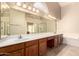 Bright bathroom featuring a large vanity with dual sinks, soaking tub, and walk-in shower, ideal for relaxation at 8627 W Morrow Dr, Peoria, AZ 85382