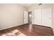 Bedroom with hardwood floors, a ceiling fan, and closet doors offers ample space and comfort at 8627 W Morrow Dr, Peoria, AZ 85382