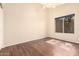 Cozy bedroom featuring hardwood floors and a window providing natural light, creating a welcoming atmosphere at 8627 W Morrow Dr, Peoria, AZ 85382