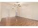 Spacious bedroom featuring hardwood floors, ceiling fan, and arched entryways, creating a bright, open feel at 8627 W Morrow Dr, Peoria, AZ 85382
