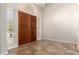Inviting foyer with double doors, tile flooring, and natural light from side windows at 8627 W Morrow Dr, Peoria, AZ 85382