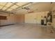 Spacious garage with painted floor, built-in cabinets, and utility equipment at 8627 W Morrow Dr, Peoria, AZ 85382