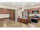 Spacious kitchen with stainless steel appliances, island, and adjacent breakfast bar seating at 8627 W Morrow Dr, Peoria, AZ 85382