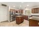 Modern kitchen with stainless steel appliances, center island, and ample countertop space at 8627 W Morrow Dr, Peoria, AZ 85382