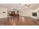 Open-concept living room with fireplace, wood floors, and an open flow to the kitchen at 8627 W Morrow Dr, Peoria, AZ 85382