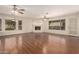 Expansive living room with fireplace, wood floors, bright windows, and high ceilings at 8627 W Morrow Dr, Peoria, AZ 85382