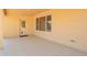 Covered patio with epoxy flooring, natural light, and a tan exterior at 8627 W Morrow Dr, Peoria, AZ 85382