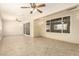 Spacious sun room with ceramic tile flooring, natural lighting, and two ceiling fans at 8627 W Morrow Dr, Peoria, AZ 85382