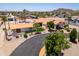 Expansive aerial view of home with circular driveway, desert landscaping, and mountain views at 920 N 104Th St, Mesa, AZ 85207