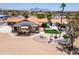Aerial view of desert home with shade structures and lush landscaping at 920 N 104Th St, Mesa, AZ 85207