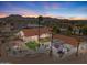 Expansive aerial view of home with firepit, landscaping and desert sunset at 920 N 104Th St, Mesa, AZ 85207
