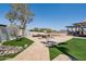 Expansive backyard featuring a seating area, artificial grass, and unique decorative elements at 920 N 104Th St, Mesa, AZ 85207