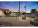 Beautiful backyard featuring a fire pit, artificial turf and desert landscaping at 920 N 104Th St, Mesa, AZ 85207