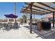 Outdoor kitchen and fireplace creates a relaxing area with ample seating for entertaining friends at 920 N 104Th St, Mesa, AZ 85207