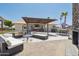 A covered outdoor living area, fireplace, and kitchen creates a relaxing space for entertaining at 920 N 104Th St, Mesa, AZ 85207