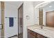 Well-lit bathroom boasts granite counters, updated fixtures, and a dark wood door at 920 N 104Th St, Mesa, AZ 85207
