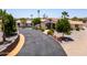 A front aerial view of a custom home with circular driveway and mature desert landscaping at 920 N 104Th St, Mesa, AZ 85207