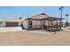 View of the house and detached garage, complete with wooden pergola and exterior lighting at 920 N 104Th St, Mesa, AZ 85207
