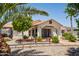Beautiful home showcasing a covered entryway, manicured lawn, and a charming wooden fence at 920 N 104Th St, Mesa, AZ 85207