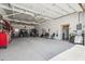Spacious garage with high ceilings, dual off-road vehicles, and ample storage space at 920 N 104Th St, Mesa, AZ 85207