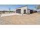 Detached garage with basketball hoop and adjacent covered porch with exterior door at 920 N 104Th St, Mesa, AZ 85207
