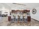 Spacious kitchen featuring modern lighting, updated appliances, a breakfast bar with chairs, and eat-in table at 920 N 104Th St, Mesa, AZ 85207