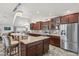 Modern kitchen featuring granite countertops, bar seating, stainless steel appliances, and recessed lighting at 920 N 104Th St, Mesa, AZ 85207