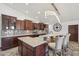 Updated kitchen with stone accents, modern appliances, a breakfast bar with seating, and stylish pendants at 920 N 104Th St, Mesa, AZ 85207