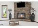 Living room with a stone fireplace, black hearth, modern ottoman and vases at 920 N 104Th St, Mesa, AZ 85207
