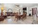 Inviting living room with a large leather sofa, a brick accent wall, and plenty of seating at 920 N 104Th St, Mesa, AZ 85207