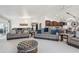 Bright, open living room features modern furniture, a chandelier, and leads to a well-equipped kitchen area at 920 N 104Th St, Mesa, AZ 85207