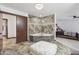 Bright main bath with soaking tub, chandelier lighting and tile accents at 920 N 104Th St, Mesa, AZ 85207