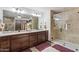 Bright main bath featuring a tiled shower, spacious vanity and modern lighting at 920 N 104Th St, Mesa, AZ 85207