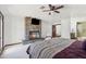 Bright main bedroom featuring a stone fireplace, ceiling fan and doorway to the main bath at 920 N 104Th St, Mesa, AZ 85207