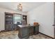Home office featuring custom built-in bookshelves, a comfortable chair, and a neutral color palette at 920 N 104Th St, Mesa, AZ 85207