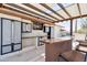 Custom outdoor kitchen boasts stainless steel storage, copper bar, and comfortable seating at 920 N 104Th St, Mesa, AZ 85207