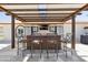 Outdoor kitchen is complete with seating, tv and outdoor refrigerators perfect for outdoor dining at 920 N 104Th St, Mesa, AZ 85207