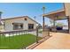 Spacious outdoor patio with ample seating, a ceiling fan, and an artificial turf area at 920 N 104Th St, Mesa, AZ 85207